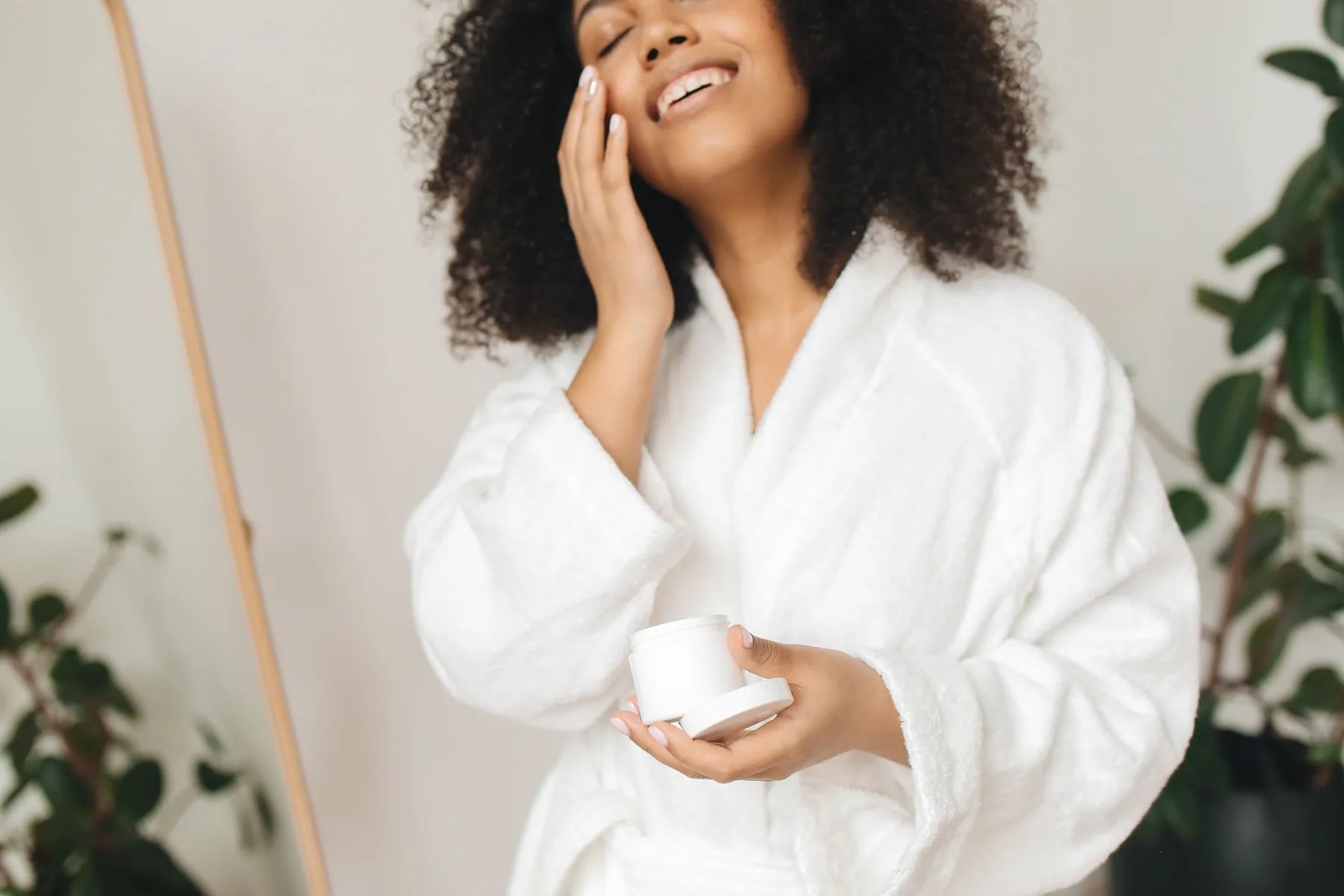 Woman applying face cream during her skincare routine