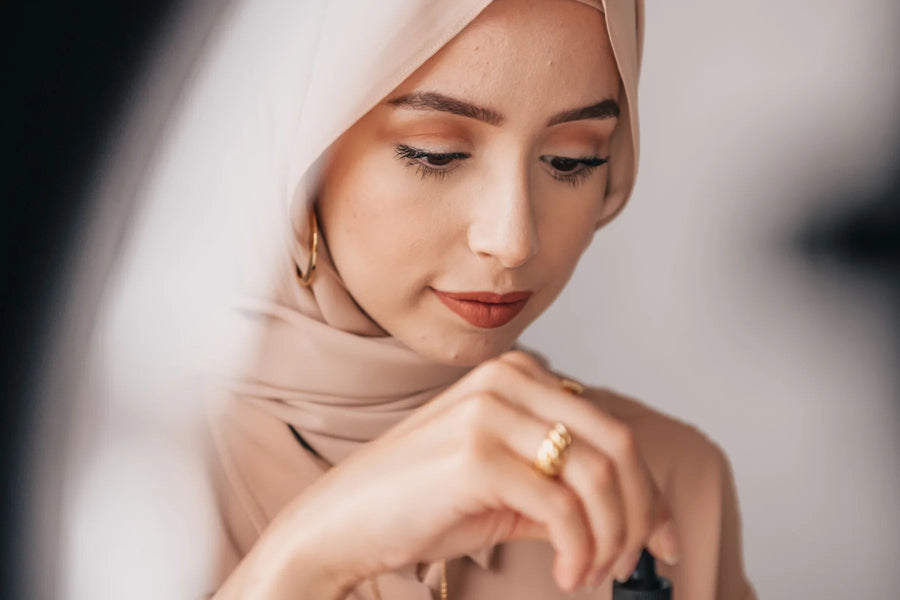 Woman preparing a skincare serum during her routine