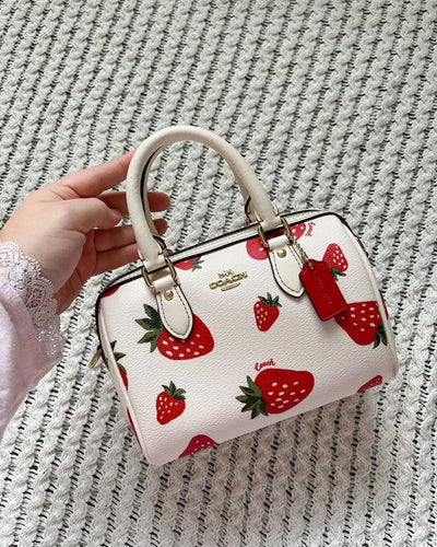 Coach Mini Rowan Crossbody bag with a wild strawberry print
