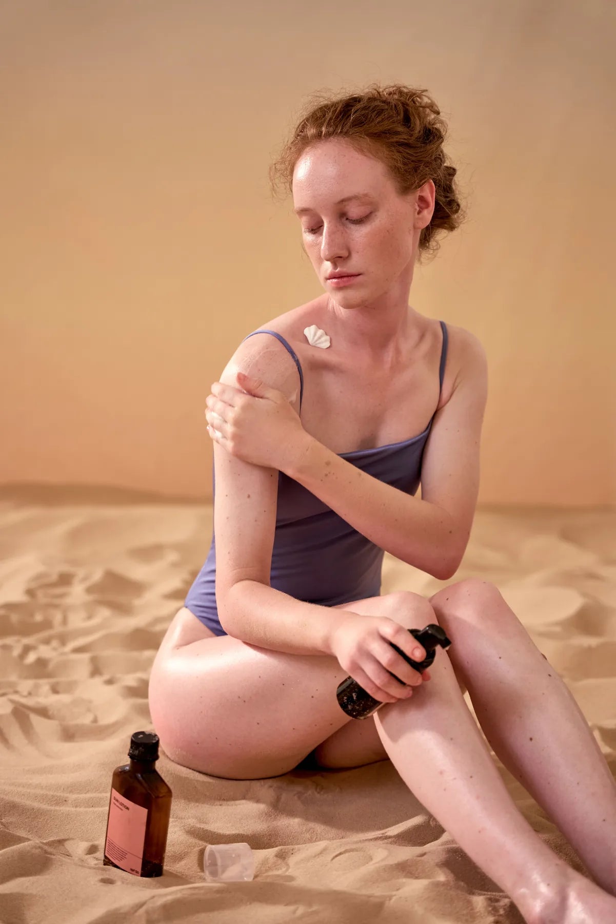 Woman applying sunscreen to exposed skin in natural light