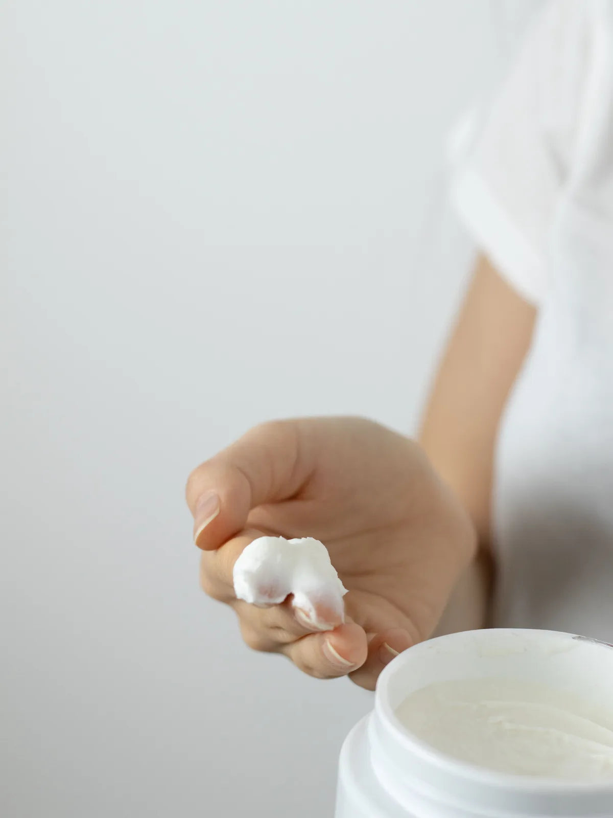 Close-up of a small amount of moisturizer on fingertips